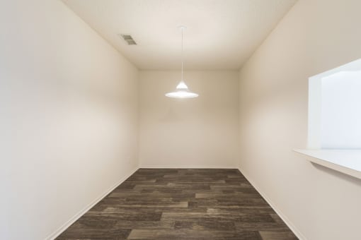 a white room with a lamp and a window