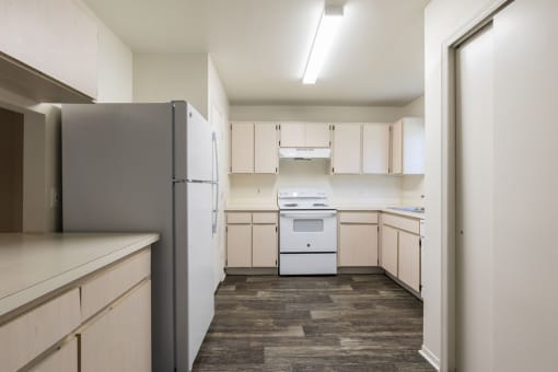 a kitchen with white appliances and white cabinets