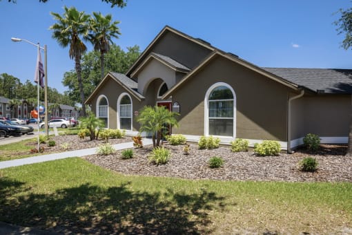 a house with a lawn and plants in front of it