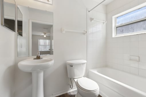 a bathroom with a sink toilet and a bath tub