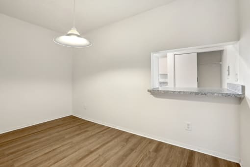 an empty room with white walls and a window