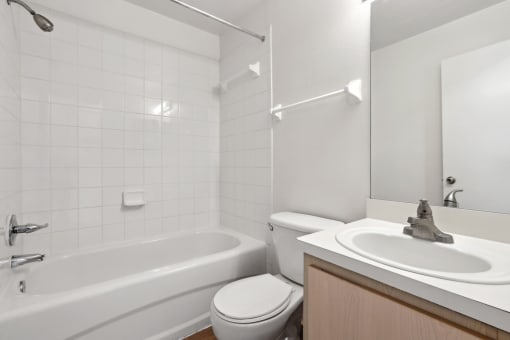 a bathroom with a sink toilet and a bath tub