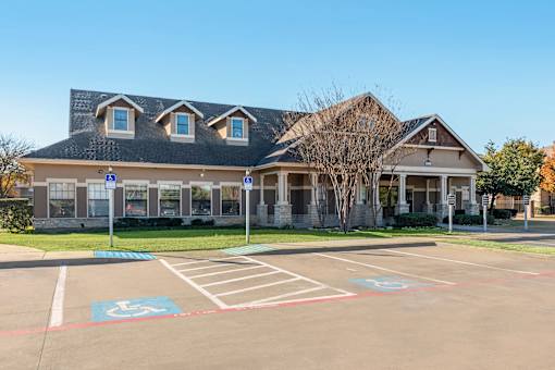 A building with a parking lot in front of it.