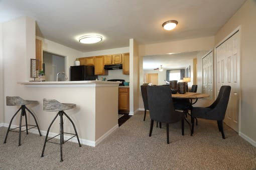The Dining Room is connected to the galley-style kitchen on the left side. Along the wall are a large mirror and two bifold closet doors at the pantry.