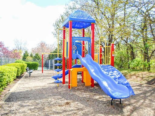 A playground with a blue slide and a red and yellow structure.