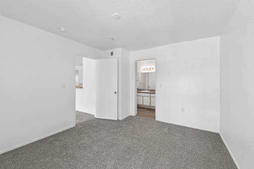 A room with a carpeted floor and white walls.