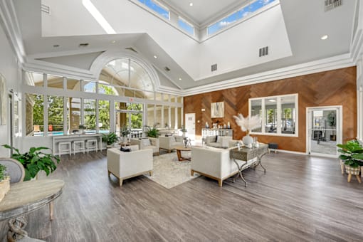 a living room filled with furniture and a large window