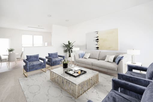 a living room with white walls and blue furniture
