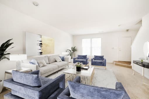 a living room with white walls and blue furniture