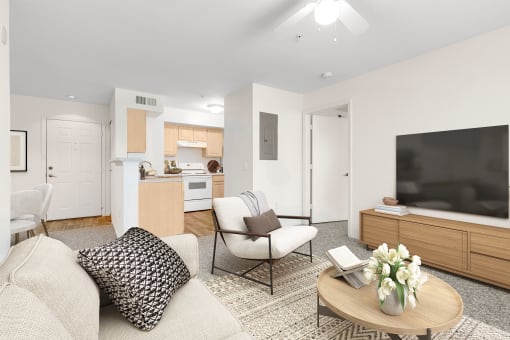 a living room with white walls and a large flat screen tv on top of a wooden cabinet