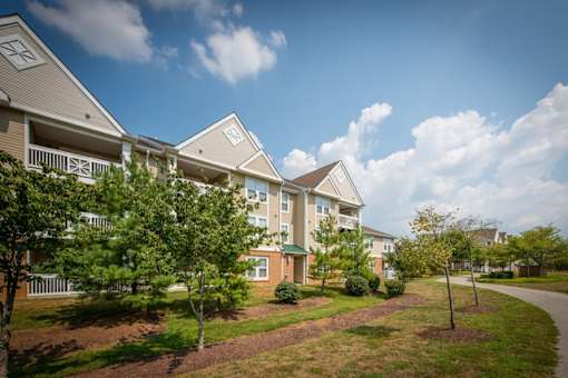 a row of townhomes with trees in front of them