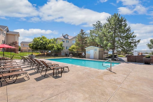 pool with umbrella-covered chairs