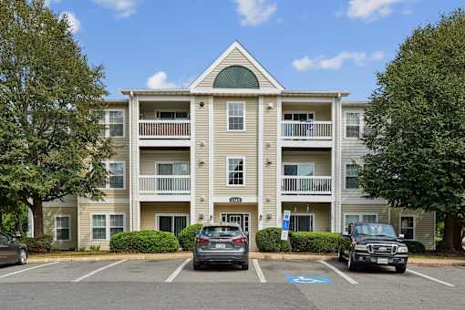 A building with a parking lot in front of it.