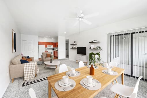 virtually staged dining and living room with carpeted flooring, ceiling fan, and sliding-door patio access