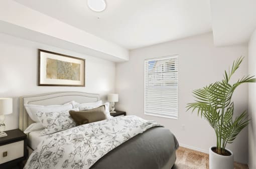 Bedroom with upholstered headboard and decorative plant at Rose Cove Homes Apartments, Farmington, 84025