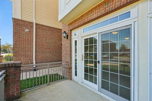 A glass door with a white frame is the main focus of the image.