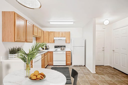 Kitchen with oak cabinets and entryway view at Rose Cove Homes Apartments, Utah