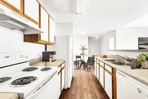 kitchen with white appliances and hardwood-style flooring