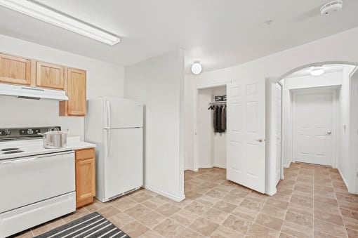 Kitchen with refrigerator and closet storage space at Rose Cove Homes Apartments, Farmington, UT 84025