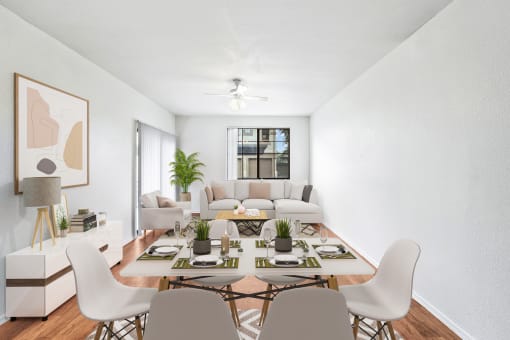 virtually staged dining and living room with hardwood-style flooring, ceiling fan, and window