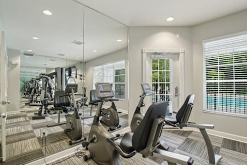 A gym with treadmills, exercise bikes and other equipment.