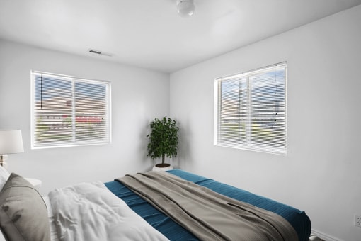 Virtually staged bedroom with bed, side table with lamp, potted plant, white walls and carpet with two windows