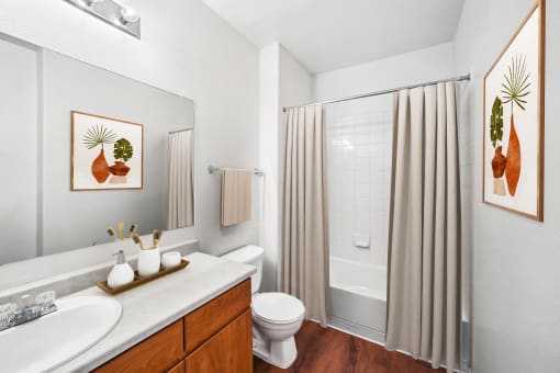 bathroom with hardwood-style flooring and wood cabinetry