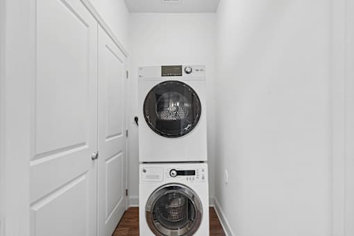 A white washing machine and dryer in a small laundry room.