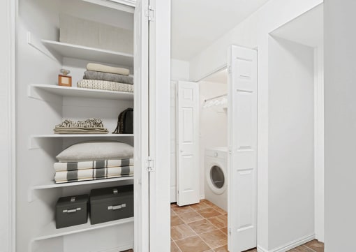 Linen closet with organized shelving and laundry room at Rose Cove Homes Apartments, Farmington, 84025