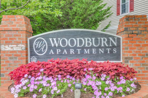 Front office signage surrounded by flowers