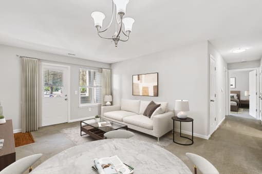 a living room with a white couch and table