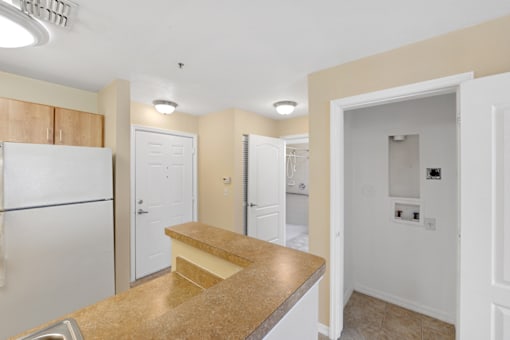 a kitchen with a sink and a refrigerator