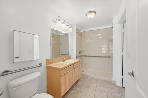 a bathroom with a toilet sink and shower