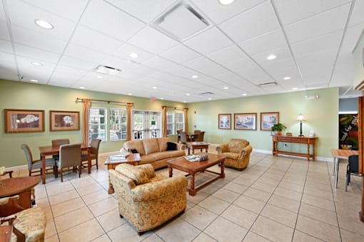 a resident clubhouse with couches chairs and tables