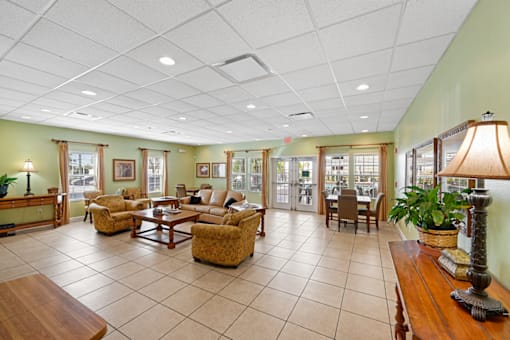 a resident clubhouse with couches chairs and tables