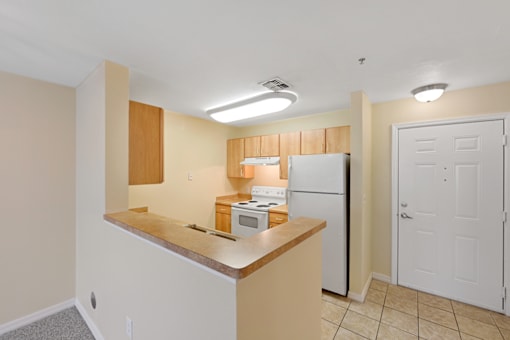 a kitchen with a white refrigerator freezer next to a stove top oven