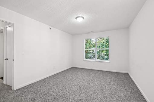 A room with a window and a door.