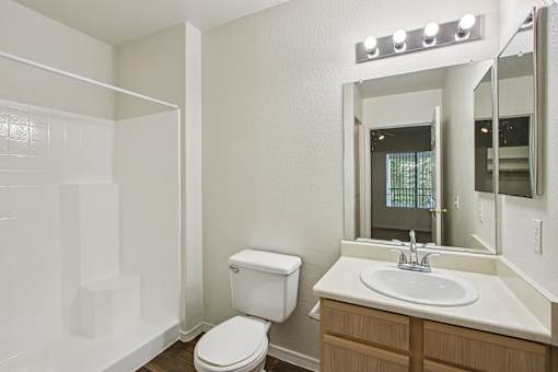 white toilet sits at The Village at Sun Valley Apartments, Arizona, 85207