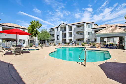 swimming pool with large tree at The Village at Sun Valley Apartments, Mesa Arizona