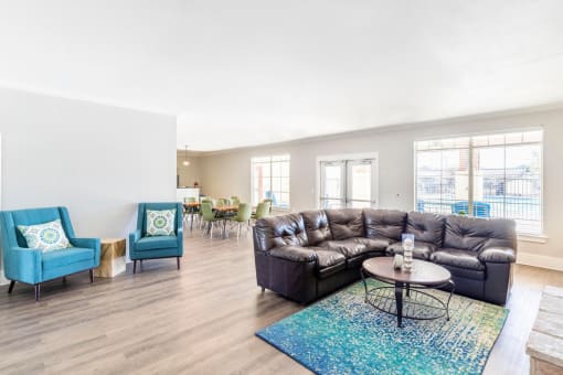 Clubhouse lounge area with arm chairs and coffee table.