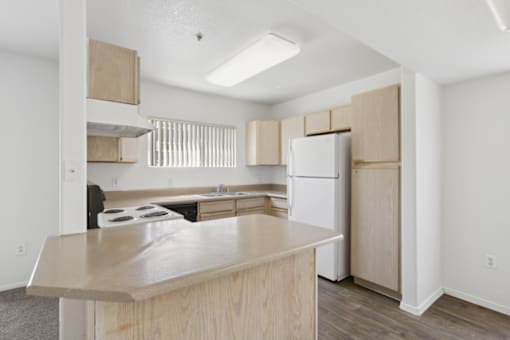 empty kitchen with table at The Village at Sun Valley Apartments, Mesa
