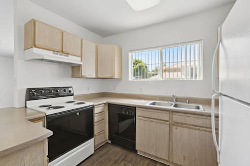 kitchen with wood cabinets at The Village at Sun Valley Apartments, Mesa, AZ 85207