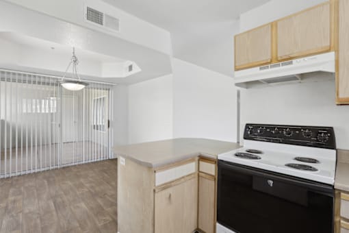 kitchen with a stove at The Village at Sun Valley Apartments, Mesa
