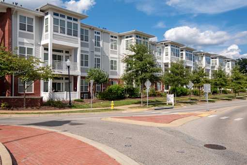 an empty street in front of an apartment building
