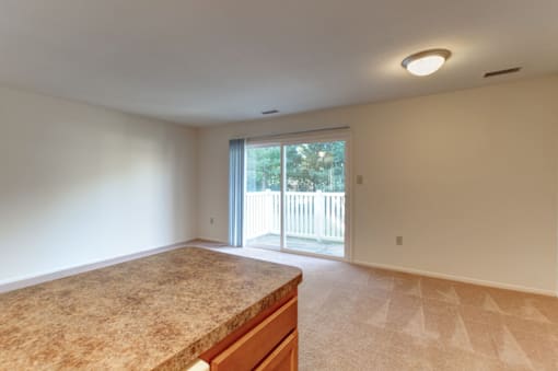 living room with a large sliding glass door leading to a balcony