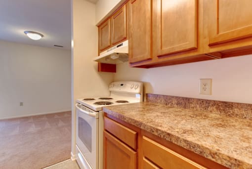 a kitchen with wood cabinets and white appliances