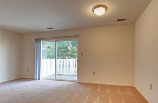 living room with a sliding glass door leading to a balcony