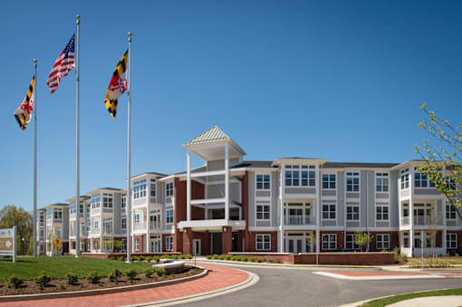 Exterior of the clubhouse with bushes and trees in front of it