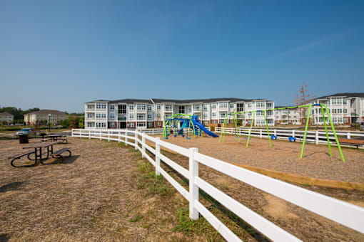 playground with white fence surrounding it