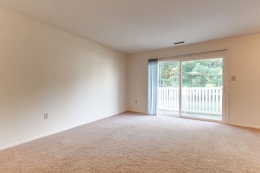 living room with a sliding glass door leading to a balcony